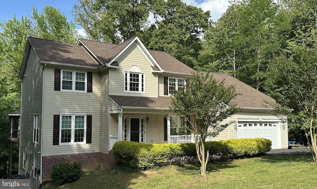 6480 Wheeler Dr, King George, VA 22485 - traditional-style home with an attached garage, covered porch, a front lawn, and a shingled roof