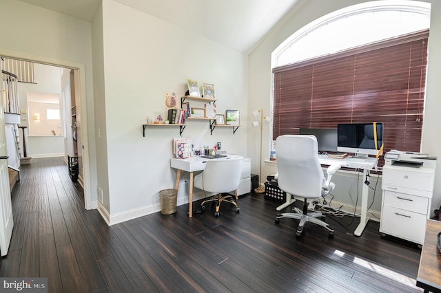 office area with dark wood finished floors, baseboards, and vaulted ceiling