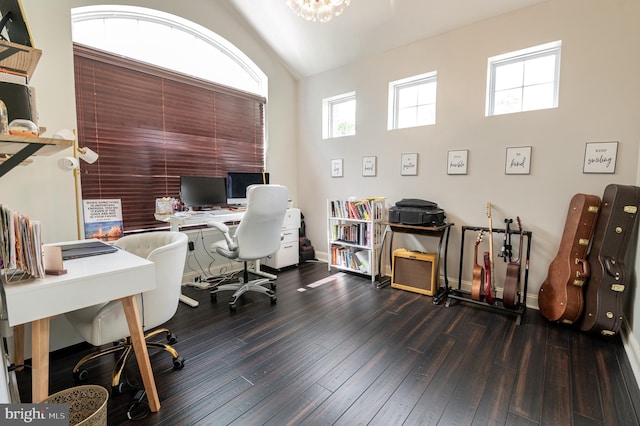 office space with hardwood / wood-style floors, baseboards, and vaulted ceiling
