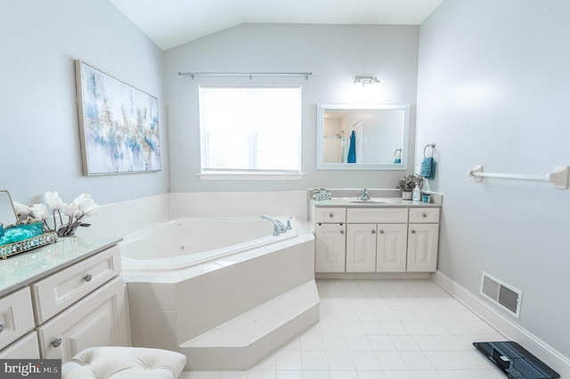bathroom featuring a whirlpool tub, tile patterned floors, vanity, and lofted ceiling