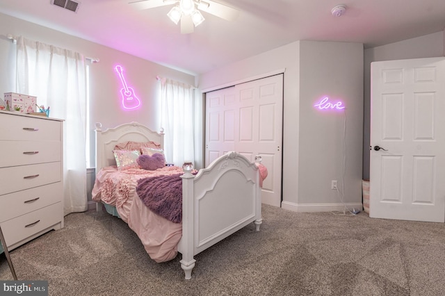 carpeted bedroom with a closet, a ceiling fan, and baseboards