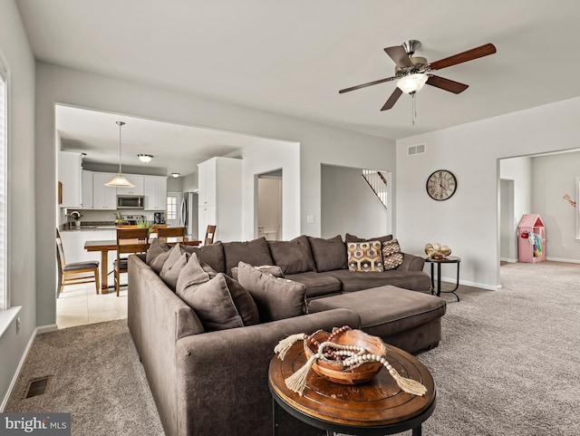 166 Spring Dale Ln, Felton, DE 19943 - living area with light carpet, a ceiling fan, baseboards, and stairway