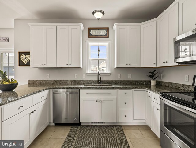 166 Spring Dale Ln, Felton, DE 19943 - kitchen with appliances with stainless steel finishes, a sink, white cabinetry, and light tile patterned floors