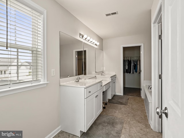 166 Spring Dale Ln, Felton, DE 19943 - full bath featuring vanity, a bath, a walk in closet, baseboards, and tile patterned floors