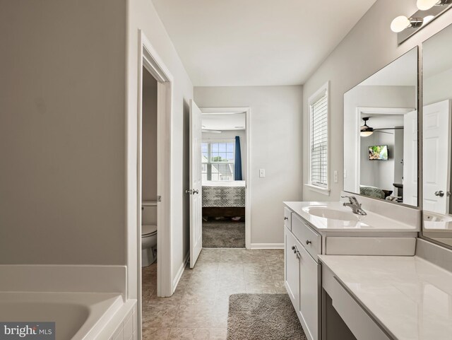 166 Spring Dale Ln, Felton, DE 19943 - ensuite bathroom featuring toilet, vanity, a ceiling fan, a tub, and baseboards