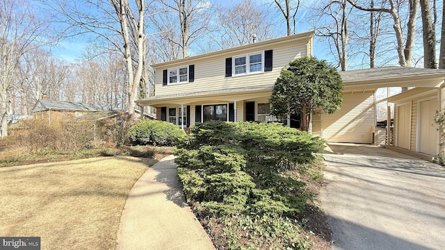 traditional-style house featuring driveway and a carport