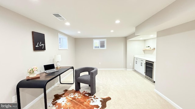 office space featuring beverage cooler, recessed lighting, light colored carpet, and baseboards