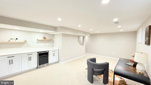 indoor bar featuring beverage cooler, light carpet, recessed lighting, and baseboards