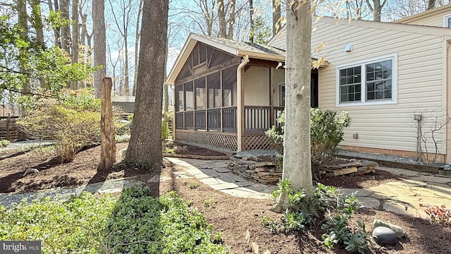 view of side of home with a sunroom