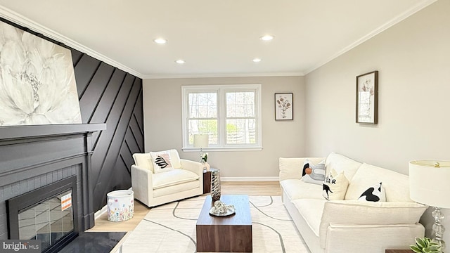 living room with wood finished floors, recessed lighting, crown molding, baseboards, and a fireplace with flush hearth