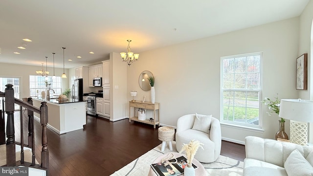 12515 Rustic Rock Ln, Beltsville, MD 20705 - living area with a chandelier, plenty of natural light, dark wood-type flooring, recessed lighting, and baseboards