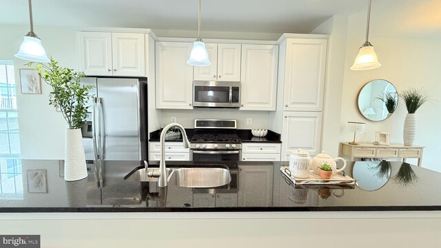 12515 Rustic Rock Ln, Beltsville, MD 20705 - kitchen with appliances with stainless steel finishes, a sink, white cabinetry, and hanging light fixtures