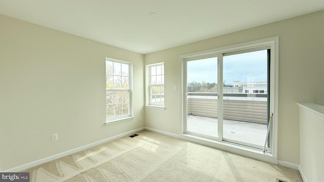 12515 Rustic Rock Ln, Beltsville, MD 20705 - empty room with baseboards, light carpet, and plenty of natural light