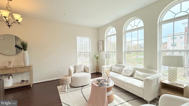 12515 Rustic Rock Ln, Beltsville, MD 20705 - living room featuring a chandelier, wood finished floors, and baseboards