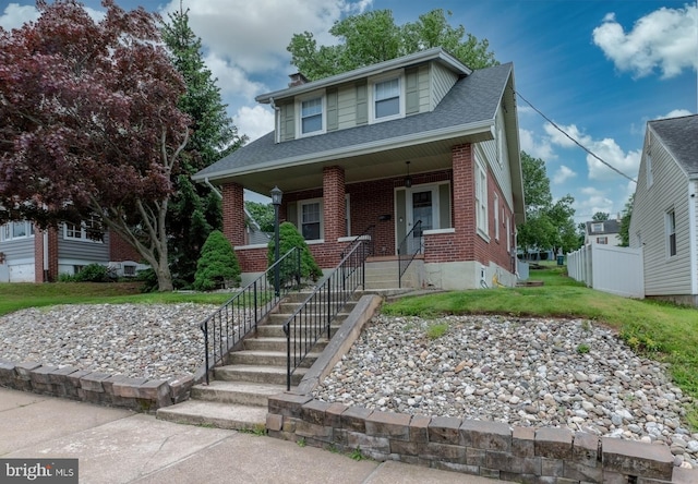 506 W 3rd St, Birdsboro, PA 19508 - view of front of house featuring brick siding, a porch, roof with shingles, and a chimney