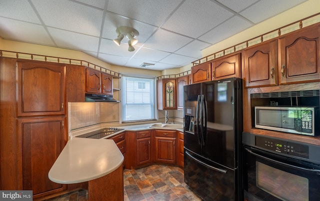 506 W 3rd St, Birdsboro, PA 19508 - kitchen featuring black appliances, a sink, a drop ceiling, under cabinet range hood, and stone finish floors