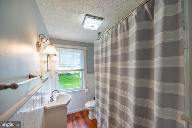 506 W 3rd St, Birdsboro, PA 19508 - bathroom featuring a textured ceiling, toilet, wood finished floors, vanity, and wainscoting