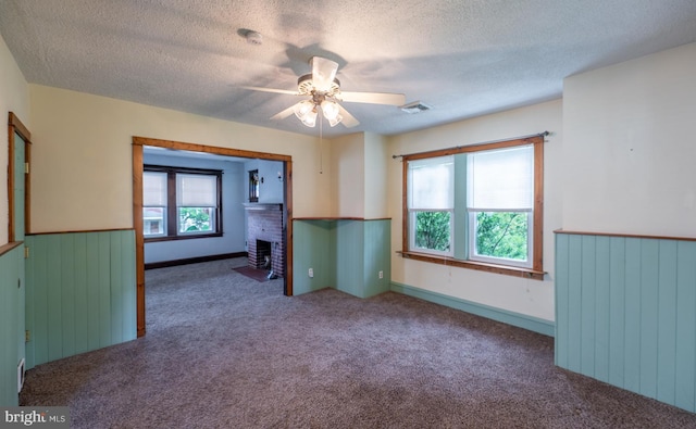 506 W 3rd St, Birdsboro, PA 19508 - empty room with carpet, a ceiling fan, a textured ceiling, a fireplace, and a smoke detector