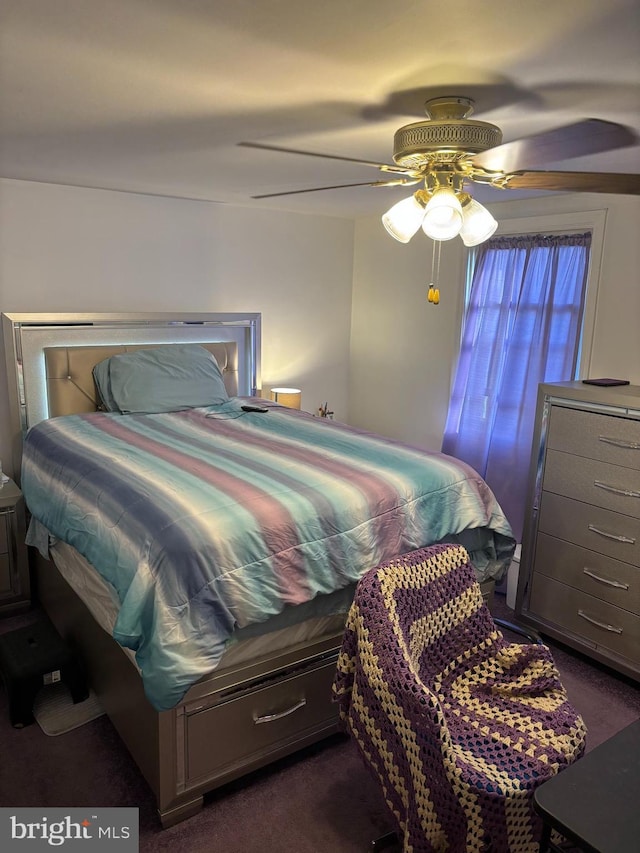 bedroom featuring dark carpet and a ceiling fan