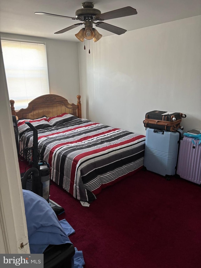 carpeted bedroom with radiator heating unit and ceiling fan