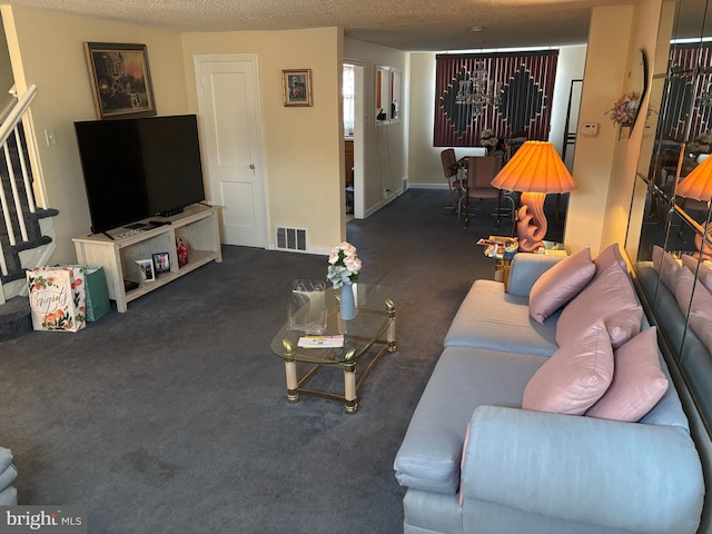 living room featuring carpet floors and a textured ceiling