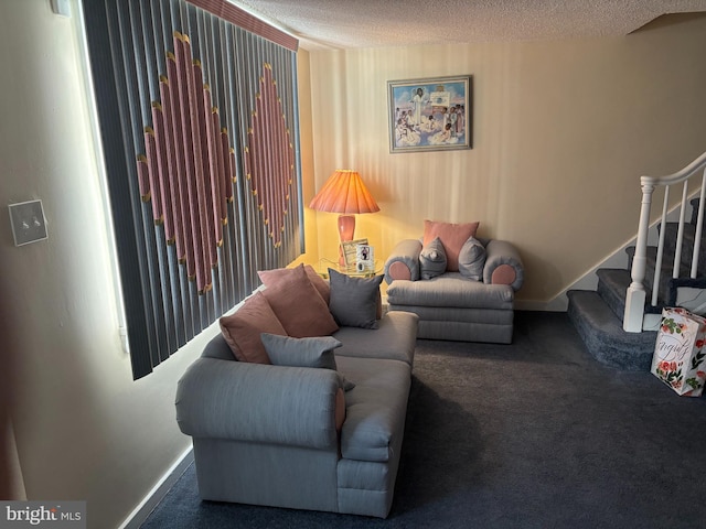 living room featuring carpet floors, stairs, a textured ceiling, and baseboards