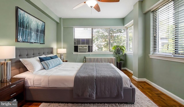 bedroom with radiator, multiple windows, cooling unit, and baseboards
