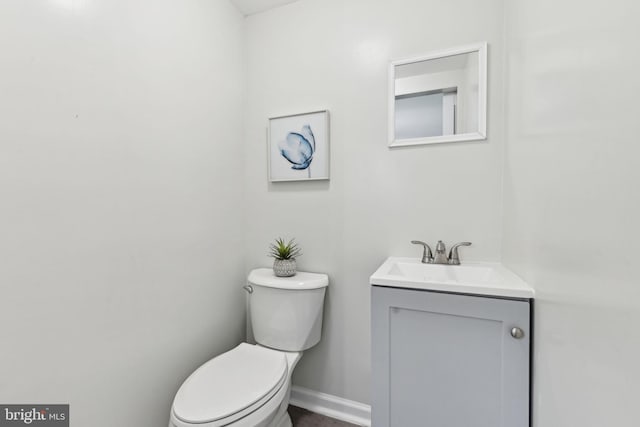4850 Eastern Ave NE, Washington, DC 20017 - half bathroom featuring toilet, vanity, and baseboards