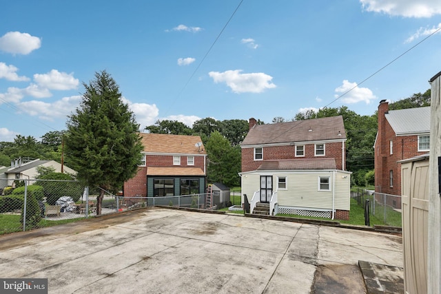4850 Eastern Ave NE, Washington, DC 20017 - back of house featuring entry steps, brick siding, and a gate