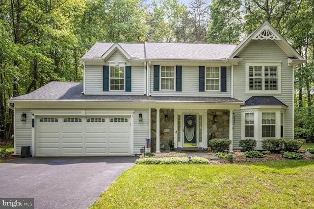 view of front of property with asphalt driveway, covered porch, a front lawn, and roof with shingles