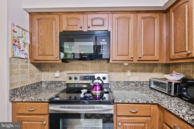 kitchen with black microwave, stainless steel electric stove, brown cabinets, and backsplash