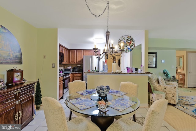 dining room with a chandelier and light tile patterned floors
