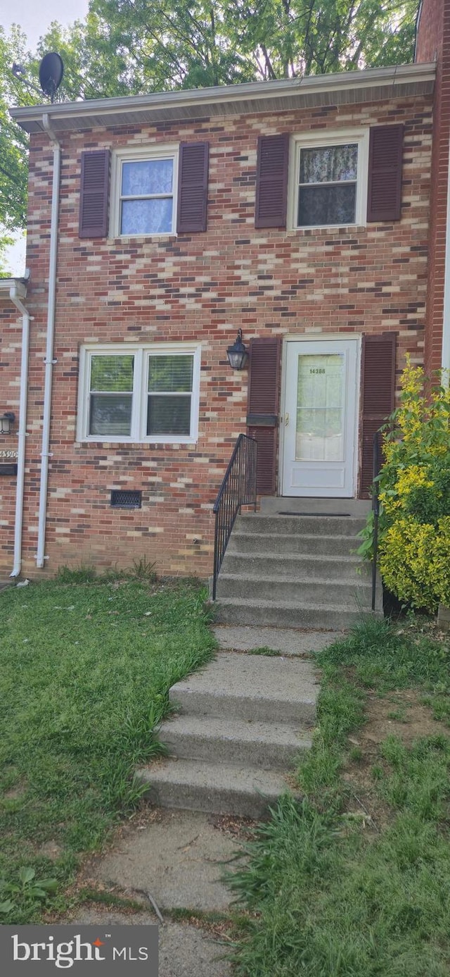 view of property featuring brick siding