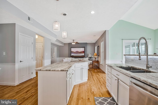 455 Creeks End Ln, Stevensville, MD 21666 - kitchen featuring dishwasher, a sink, open floor plan, white cabinets, and light wood-type flooring