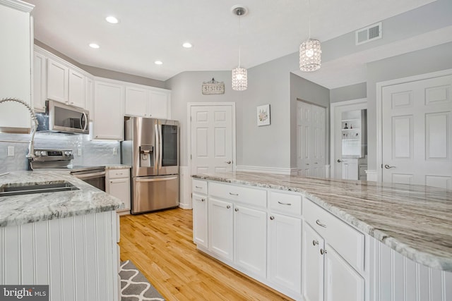 455 Creeks End Ln, Stevensville, MD 21666 - kitchen featuring stainless steel appliances, recessed lighting, white cabinets, tasteful backsplash, and light wood-style flooring