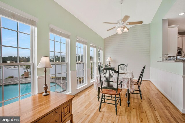 455 Creeks End Ln, Stevensville, MD 21666 - dining space featuring light wood finished floors, a ceiling fan, high vaulted ceiling, and wood walls