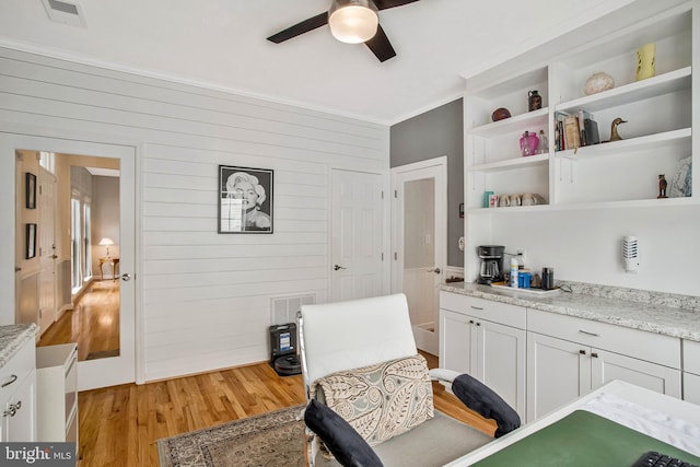 455 Creeks End Ln, Stevensville, MD 21666 - sitting room with light wood-style floors, a ceiling fan, wooden walls, and crown molding