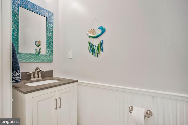 455 Creeks End Ln, Stevensville, MD 21666 - bathroom with wainscoting, vanity, and a decorative wall