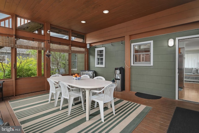 sunroom / solarium featuring outdoor dining area