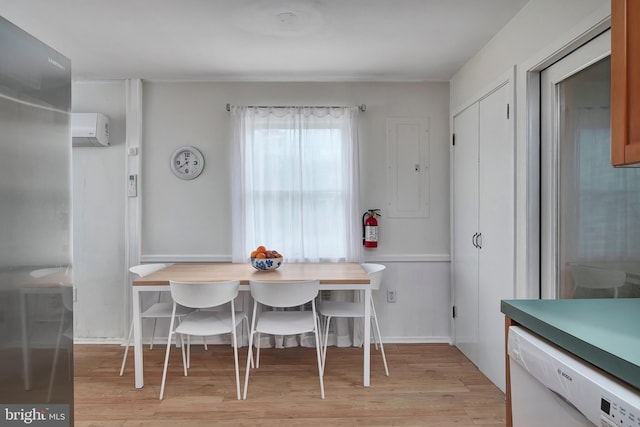 dining space featuring an AC wall unit and light wood-type flooring