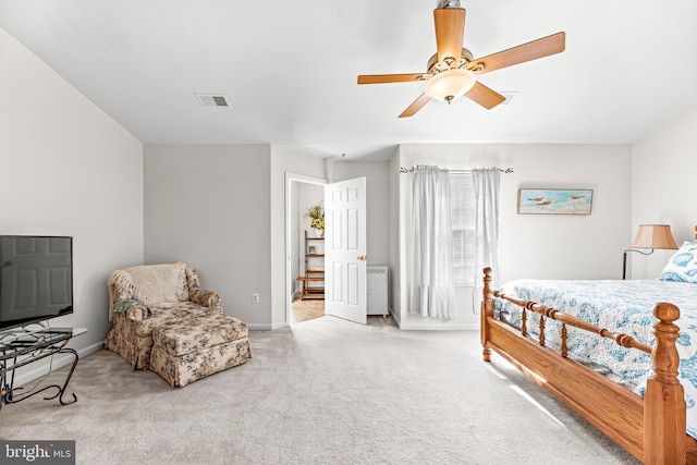 bedroom with carpet floors, radiator heating unit, baseboards, and ceiling fan