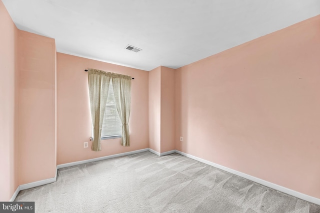 unfurnished room with baseboards and carpet flooring