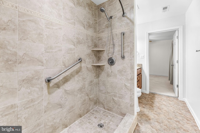 full bath with a tile shower and vanity