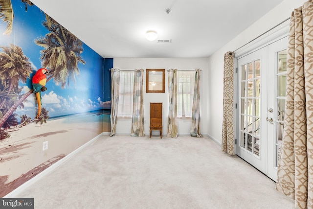 unfurnished room featuring french doors, carpet floors, and baseboards