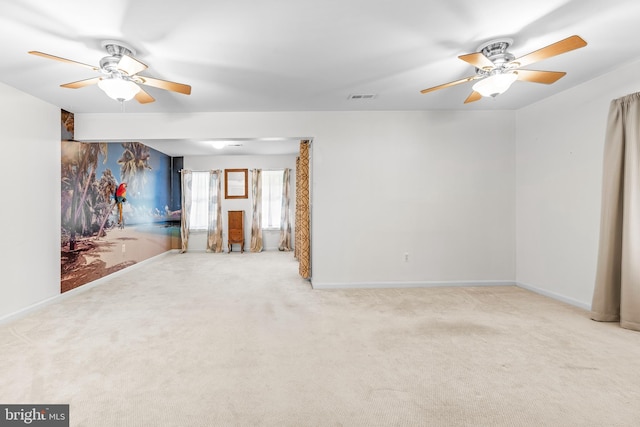 unfurnished room featuring a ceiling fan, carpet floors, and baseboards