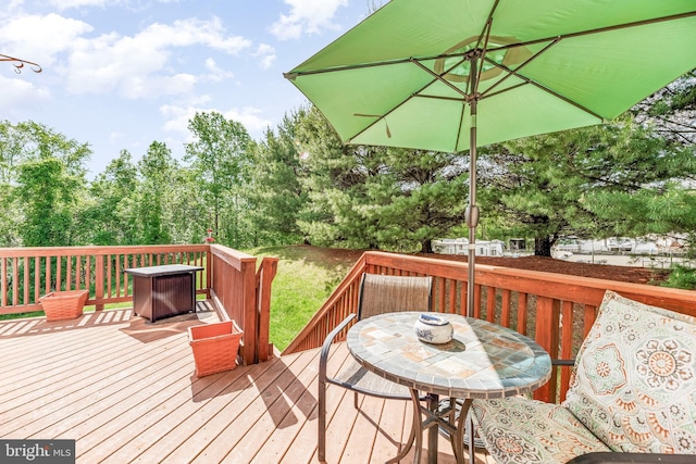wooden terrace with outdoor dining area