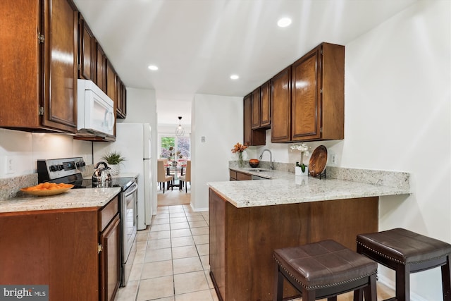 10903 Pebble Run Dr, Silver Spring, MD 20902 - kitchen featuring stainless steel electric stove, white microwave, a peninsula, light tile patterned floors, and a breakfast bar