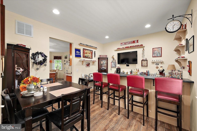 119 Mumfords Landing Rd, Ocean Pines, MD 21811 - dining space with wood finished floors, a dry bar, and recessed lighting