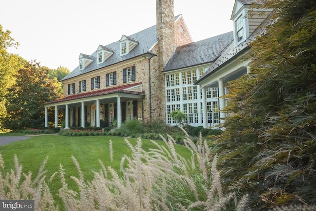 1912 Corbridge Ln, Monkton, MD 21111 - view of front facade with a front yard, a high end roof, a chimney, and brick siding