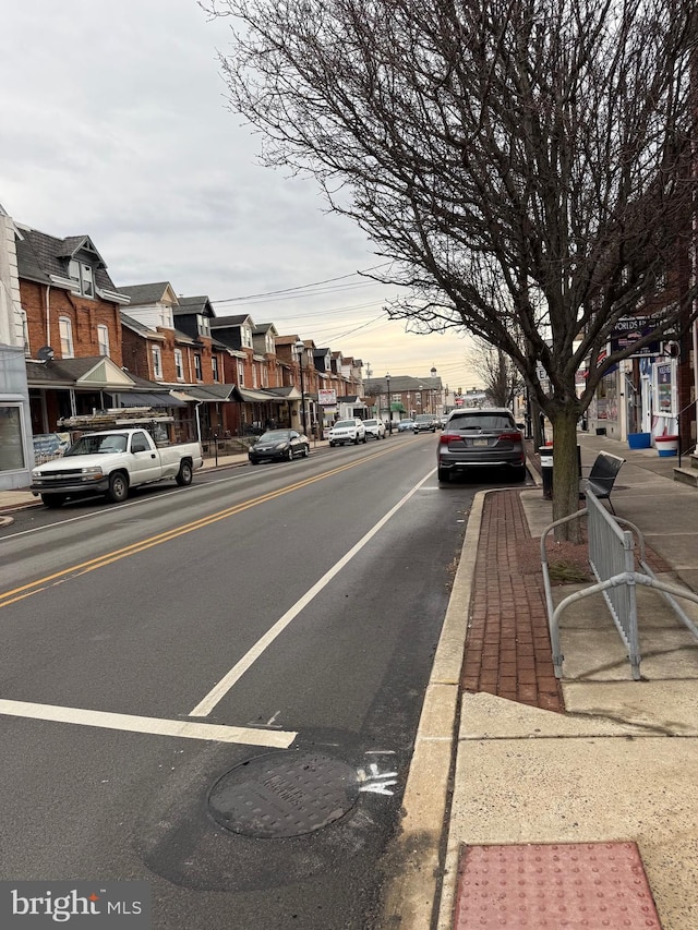 138 W 4th St, Bridgeport, PA 19405 - view of asphalt road featuring sidewalks, curbs, a residential view, and street lights